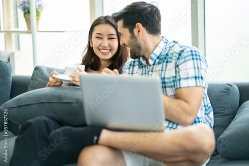 Happy young couple working on laptop at home or modern office with copy space.startup family business or work from home concept.