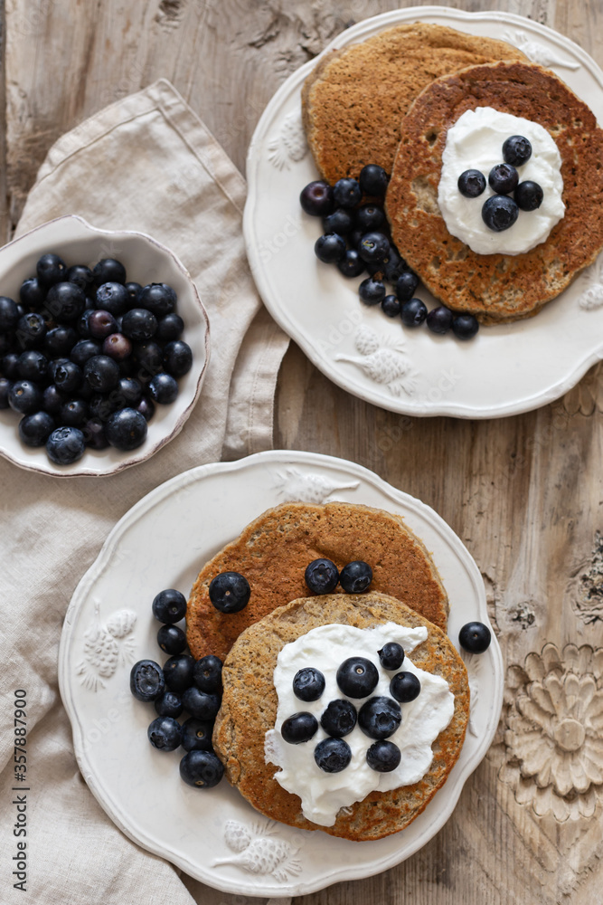 Healthy breakfast concept. Oatmeal pancakes topped with yogurt and blueberries. Healthy breakfast concept. Oatmeal pancakes topped with yogurt and blueberries.