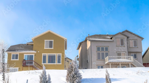 Panorama Facade of homes that sit on the snow covered slope of Wasatch Mountain in winter
