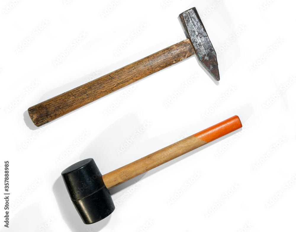 Two hammers. Rubber and steel hammers isolated on a white background. Two hammers. Rubber and steel hammers isolated on a white background.