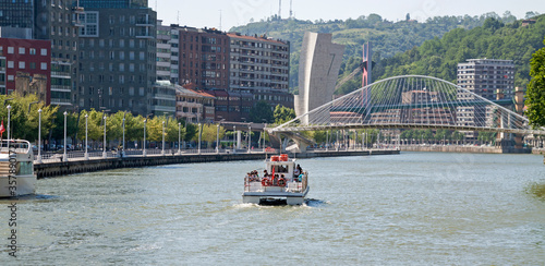 Boat surfing the estuary of Bilbao.