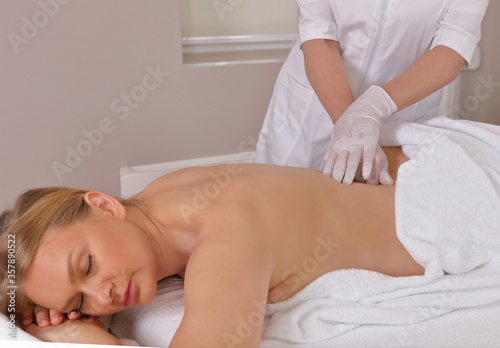Chiropractic back adjustment for female patient. Osteopathy, Physiotherapy, Injury Rehabilitation concept
