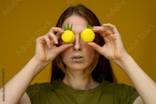 young european woman playes with fresh yellow macarons photo