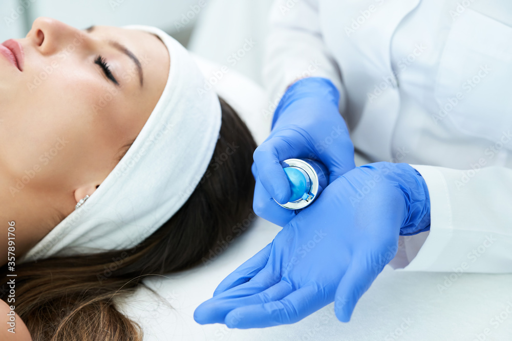 Beautiful young woman getting face treatment at beauty salon. Beautiful young woman getting face treatment at beauty salon.