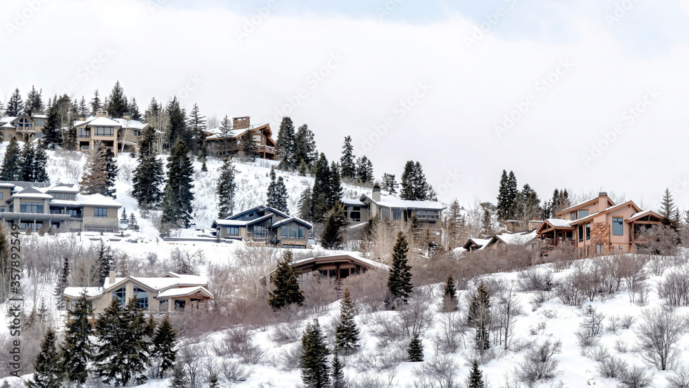 Panorama Scenic mountain in Park City Utah with houses and trees amid fresh winter snow