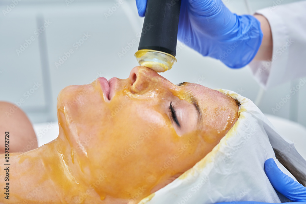 Beautiful young woman getting face treatment at beauty salon. Beautiful young woman getting face treatment at beauty salon.
