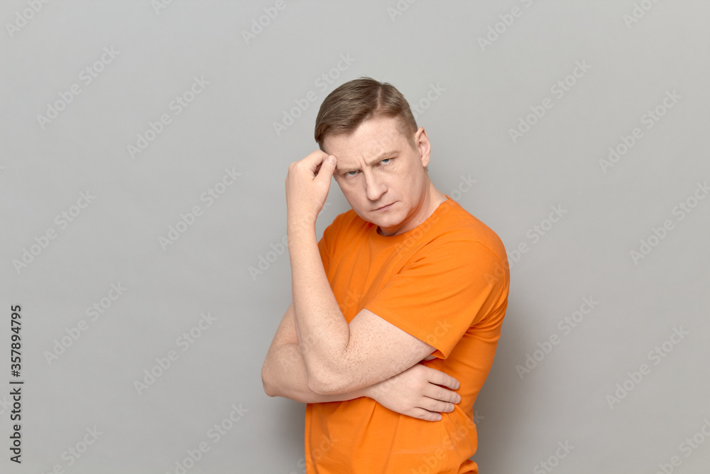 Portrait of serious man touching forehead with hand and thinking Portrait of serious man touching forehead with hand and thinking