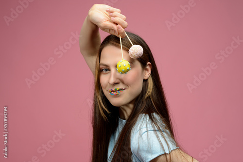 young european woman playes cake pops