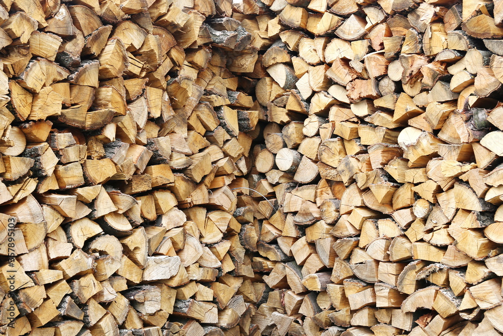 background of carefully stacked chopped firewood background of carefully stacked chopped firewood
