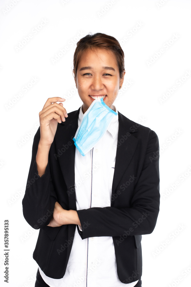 Smiling Asian businesswoman biting surgical face mask in formal black suit jacket, looking at camera, studio lighting isolated on white background, coronavirus, COVID-19 concept Smiling Asian businesswoman biting surgical face mask in formal black suit jacket, looking at camera, studio lighting isolated on white background, coronavirus, COVID-19 concept