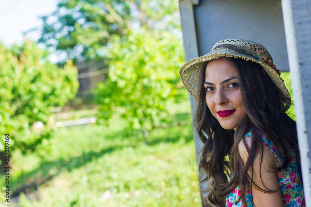 the beautiful young woman looking from a window