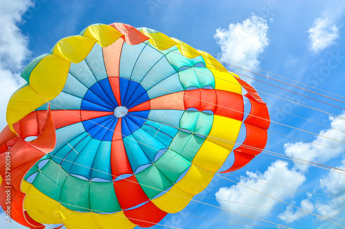 Fototapeta Naklejka Na Ścianę i Meble -  
Freedom Summer holiday background of colorful parachute with bright blue sky and sunlight background
