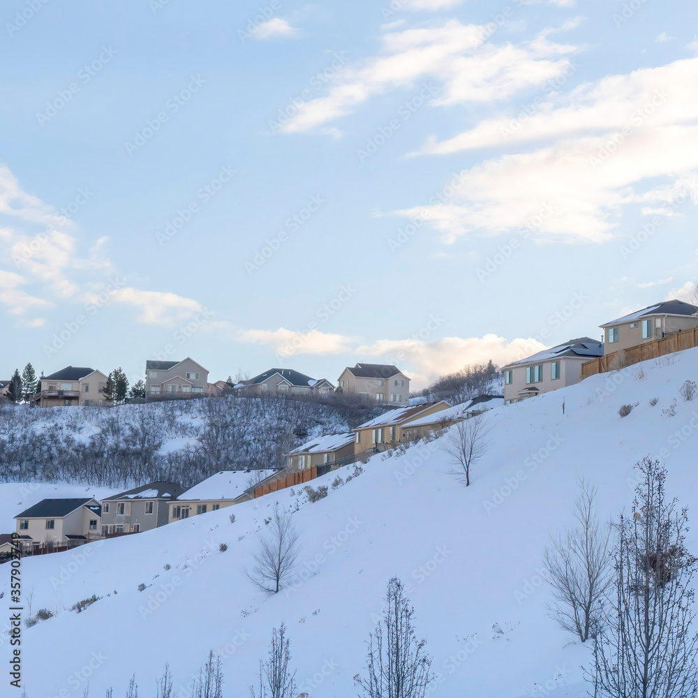 Square frame Town situated on incredible slope of Wasatch Mountains with blue sky abckground