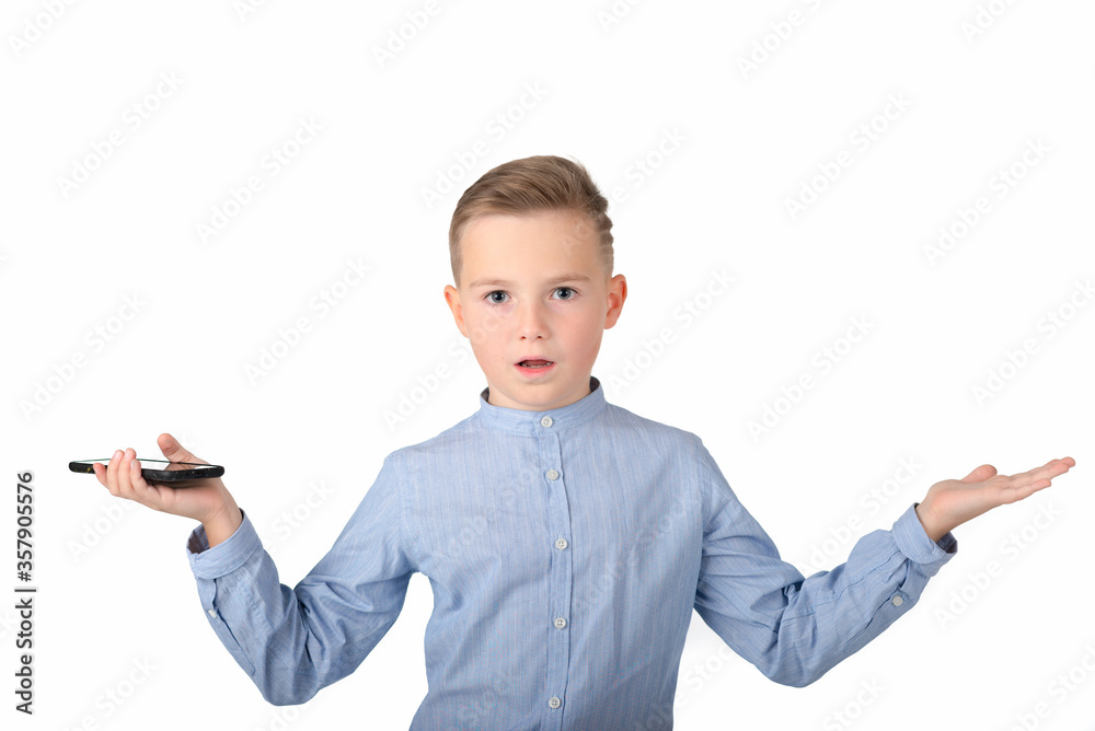 The surprised nice school boy with phone on the white background. The surprised nice school boy with phone on the white background.
