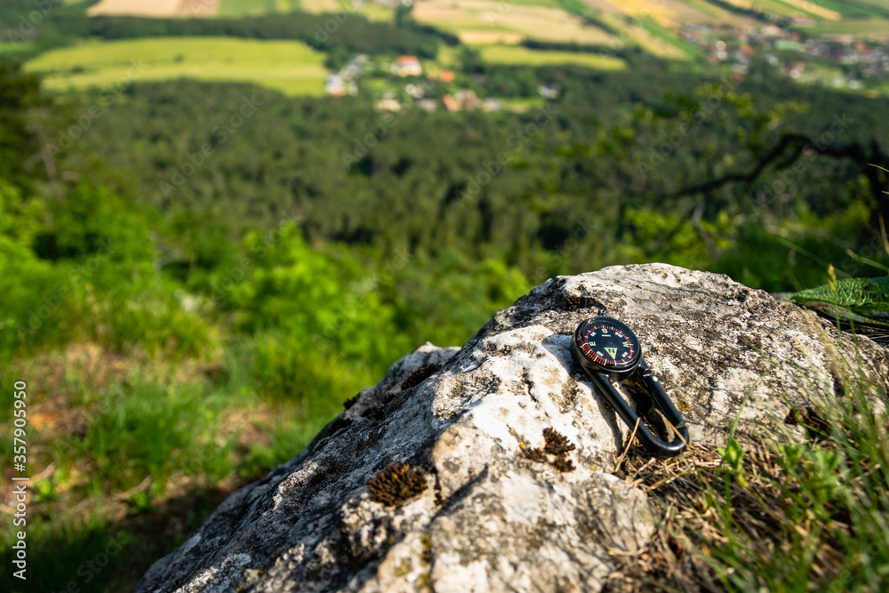 Travel concept photo of compass placed on the rock in Hohe Wand Nature Park. Lower Austria, June 2020. Travel concept photo of compass placed on the rock in Hohe Wand Nature Park. Lower Austria, June 2020.
