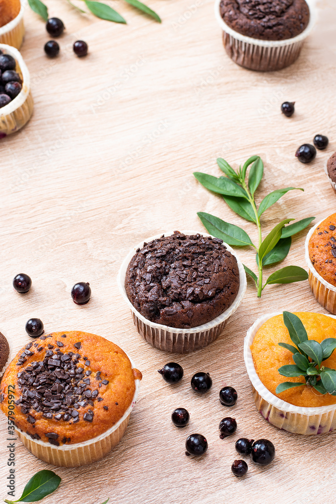 Chocolate muffin and nut muffin, homemade bakery on dark background. Muffin with blueberries on a wooden table. Fresh berries and sweet pastries on the board. Chocolate muffin and nut muffin, homemade bakery on dark background. Muffin with blueberries on a wooden table. Fresh berries and sweet pastries on the board.