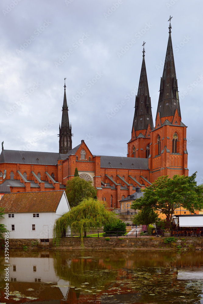 Old Uppsala Cathedral and its reflection in Fyris river. Sweden