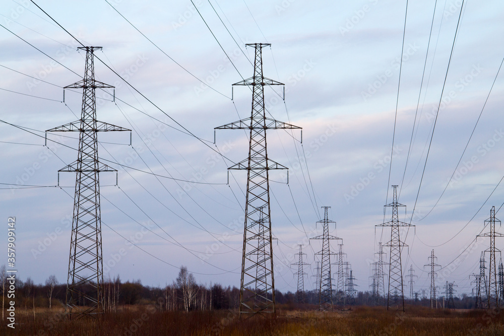 custom made wallpaper toronto digitalHigh voltage power lines in the middle of a field at sunset. Industrialization. Electrification. Power supply.