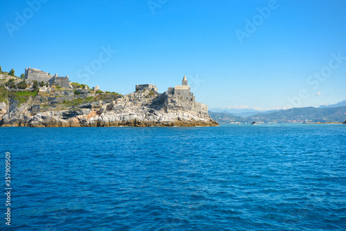 The gothic Church of St. Peter and Doria Castle on the rocky peninsula at the entrance to the gulf of Poets at Porto Venere Italy on the Ligurian Coast.