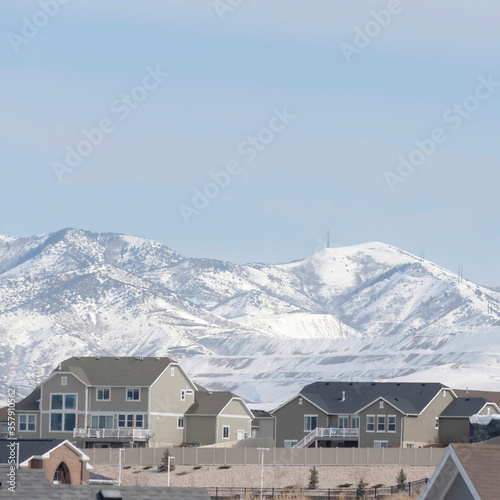 Square Neighborhood in South Jordan City against snowy Wasatch Mountains and cloudy sky © Jason