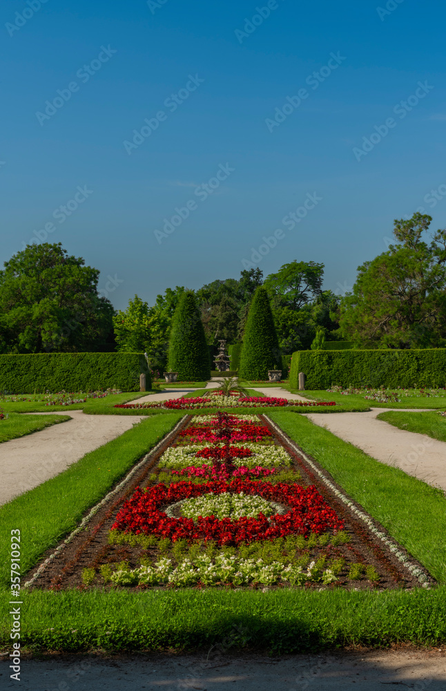 Garden near Lednice castle with color flowers in sunny day with blue sky