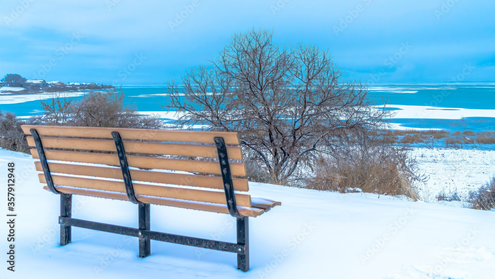Panorama Beautiful Utah Lake in winter against overcast sky viewed from an outdoor bench
