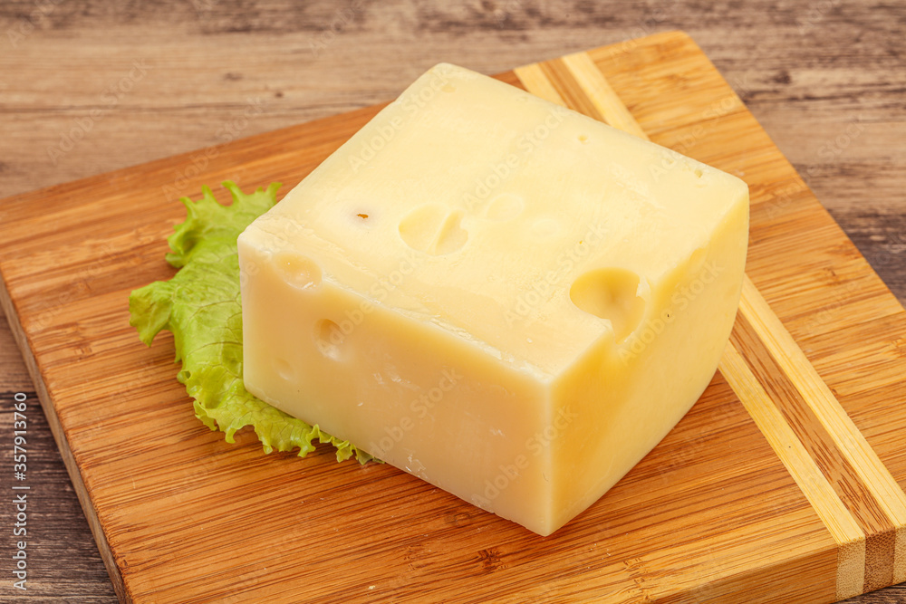 Emmental cheese over wooden board