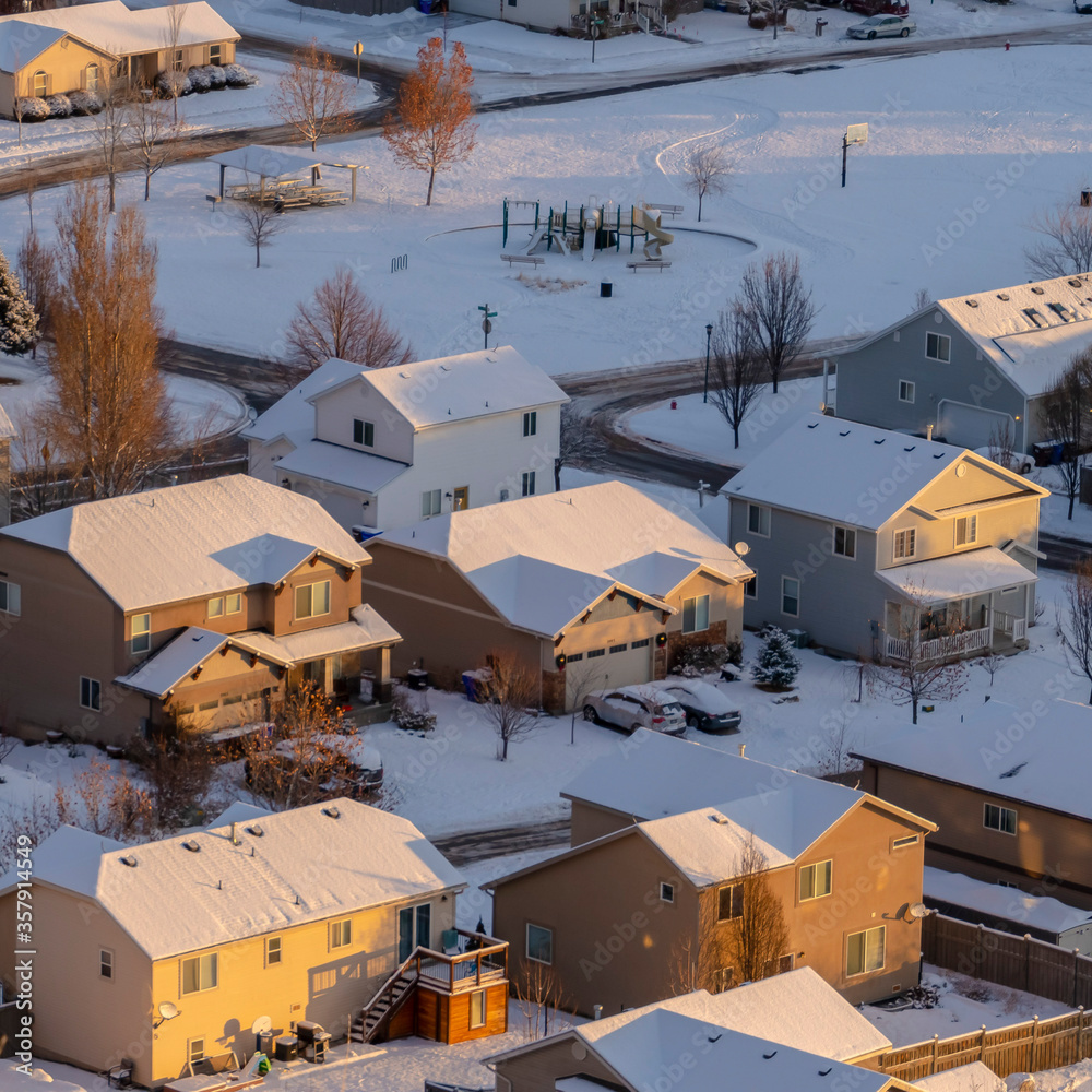 Fototapeta premium Square frame Residential neighborhood in Utah Valley on a scenic snowy aerial view in winter