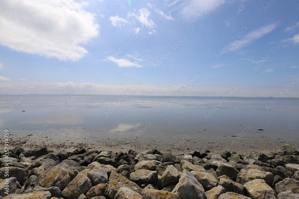 Beautiful panoramic view over the Sea at very low tide with a blue sky.