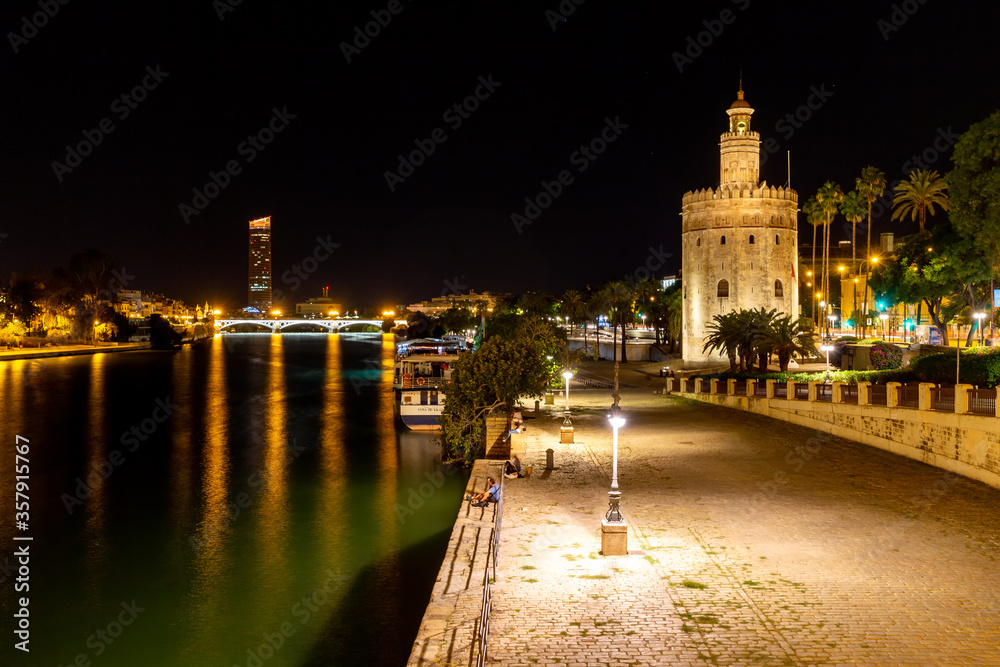 Torre del Oro at night at the Guadalquivir river in Seville, Andalucia, Spain.