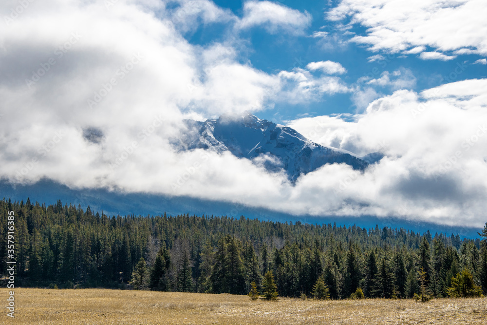 A mountain peeking through the clouds.