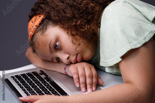 Tired frustrated hispanic girl working on computer