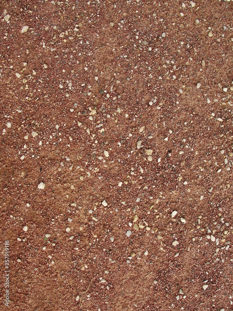 Beige stone gravel background texture. Brown small rocks abstract road pavement pattern Beige stone gravel background texture. Brown small rocks abstract road pavement pattern