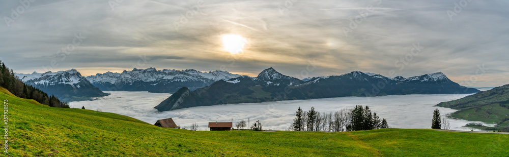 Panoramic view on clouds above lakes and on beautiful Alps
