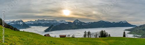 Panoramic view on clouds above lakes and on beautiful Alps