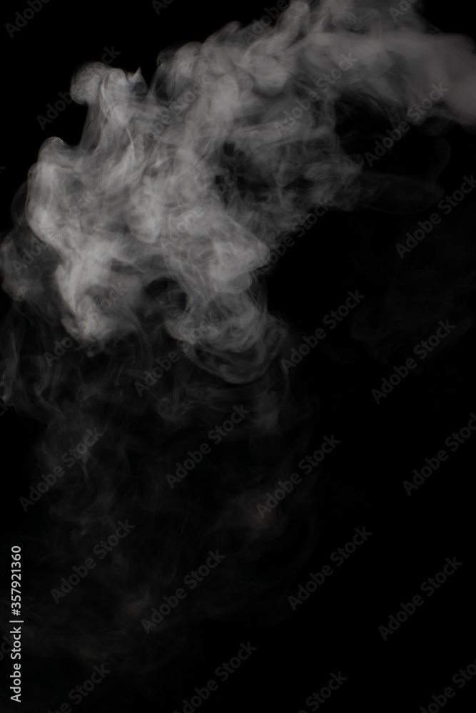 A stream of white smoke on a black background mixes randomly creating bizarre swirl patterns A stream of white smoke on a black background mixes randomly creating bizarre swirl patterns