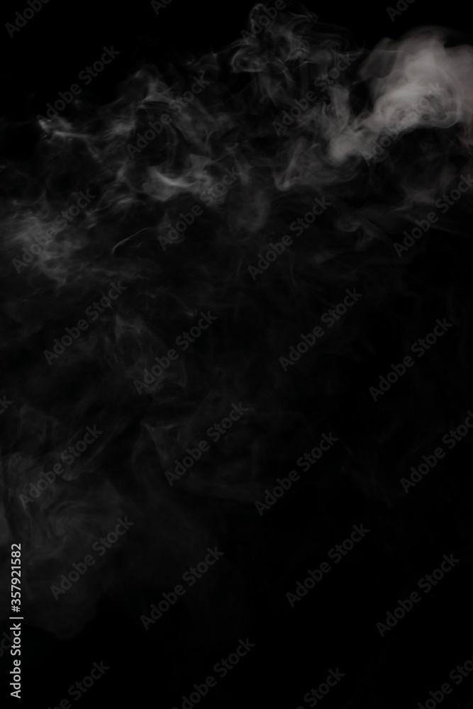 A stream of white smoke on a black background mixes randomly creating bizarre swirl patterns A stream of white smoke on a black background mixes randomly creating bizarre swirl patterns