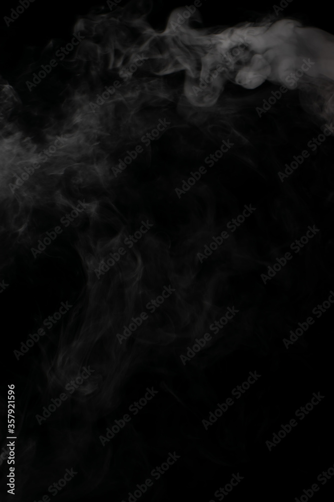 A stream of white smoke on a black background mixes randomly creating bizarre swirl patterns A stream of white smoke on a black background mixes randomly creating bizarre swirl patterns