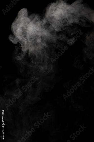 A stream of white smoke on a black background mixes randomly creating bizarre swirl patterns