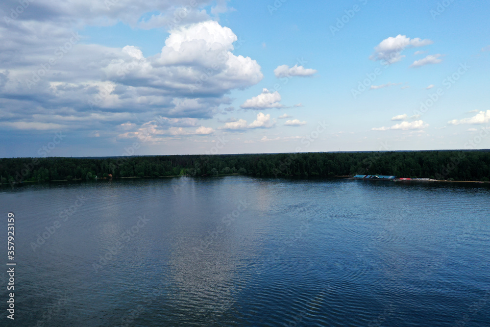 panoramic view of the river with floating boats and beautiful clouds shot from a drone