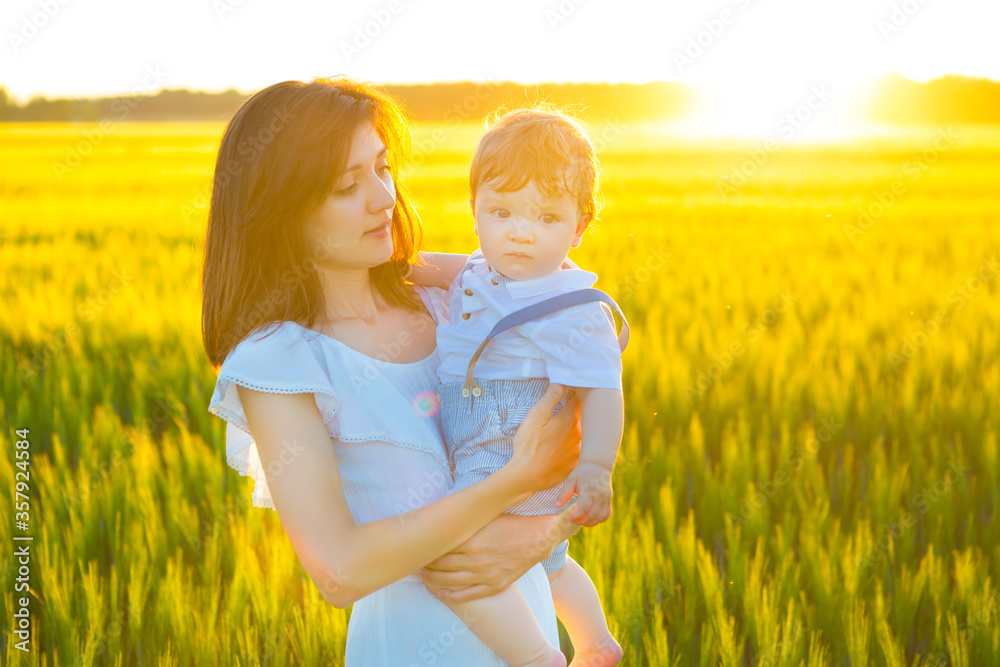 Happy family on nature outdoors mother and baby son Happy family on nature outdoors mother and baby son