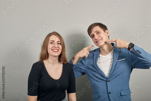 Hand pointer with forefinger pointing at itself. Index finger to show direction. Means choosing, introducing too. Indicating towards. Young attractive couple boyfriend girlfriend two people