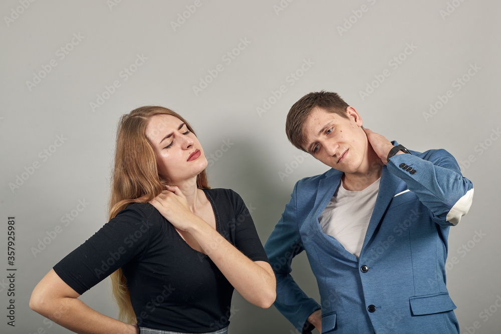 Holds the shoulder hurts, pain in my arm, sore point, problem with health care and exercise. Feel hurt. Terrible ache in spine. Exercises for back. Young attractive couple boyfriend girlfriend two Holds the shoulder hurts, pain in my arm, sore point, problem with health care and exercise. Feel hurt. Terrible ache in spine. Exercises for back. Young attractive couple boyfriend girlfriend two