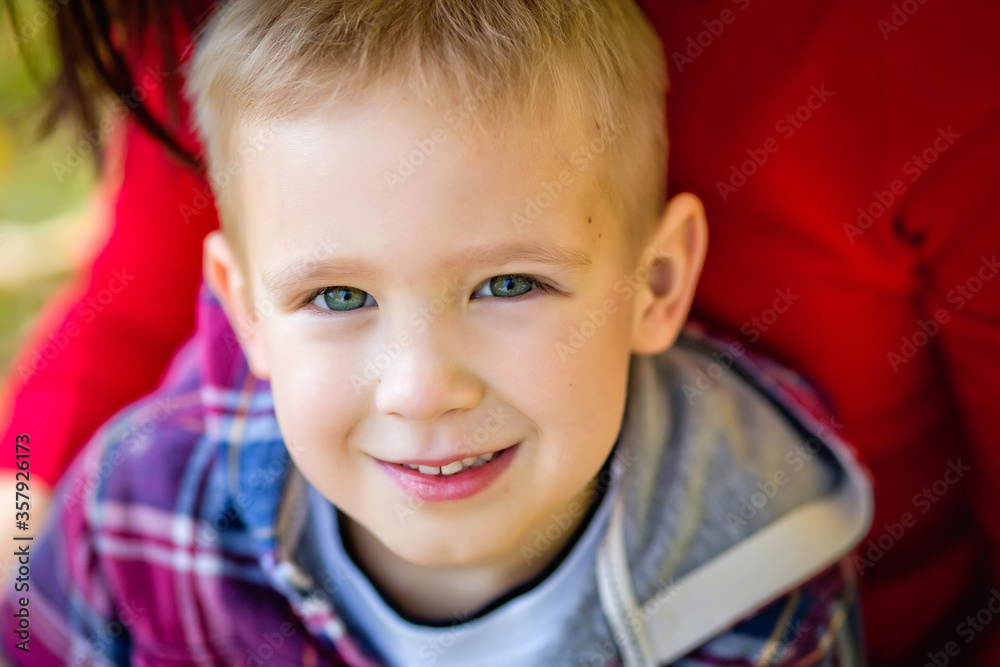 Large portrait of a boy. The child looks at the camera with a smile. Large portrait of a boy. The child looks at the camera with a smile.