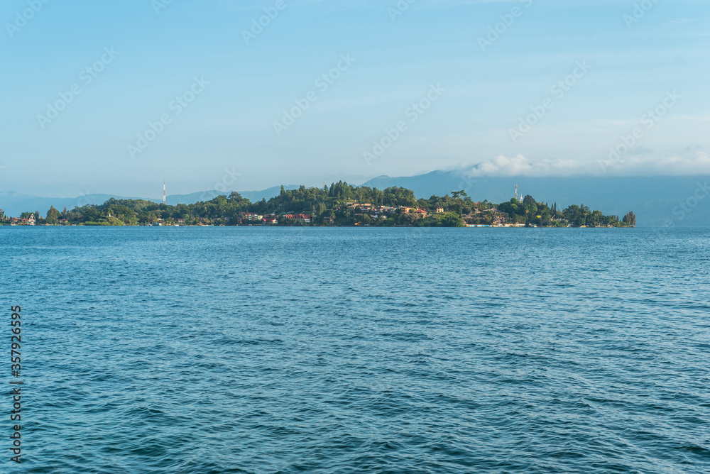 The island Samosir with the peninsula Tuktuk Siadong within the Lake Toba, the biggest volcanic lake in the world located in the middle of the northern part of the island of Sumatra 