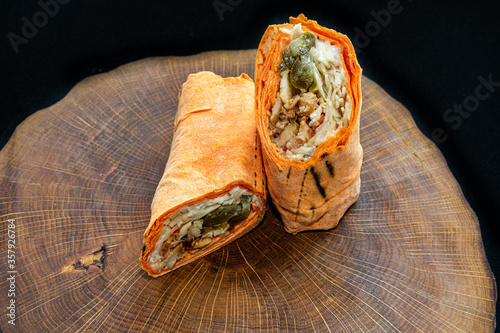 shawarma cut in half on a wooden background photo