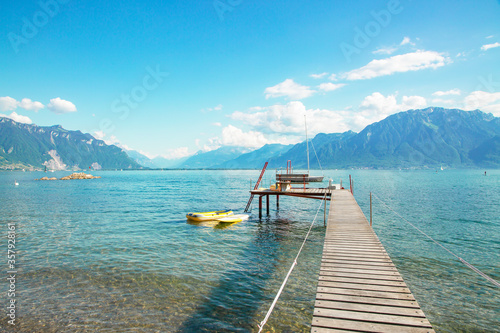 Lake view With a long bridge walkway for swimming and mountains In the summertime in Europe, traveling for a holiday with family