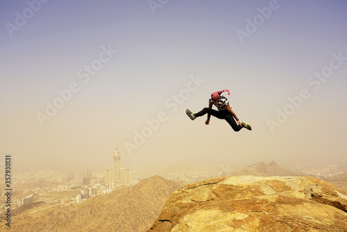 Jumping guy at Jabal Thawr high mountain, Meca, Saudi Arabia