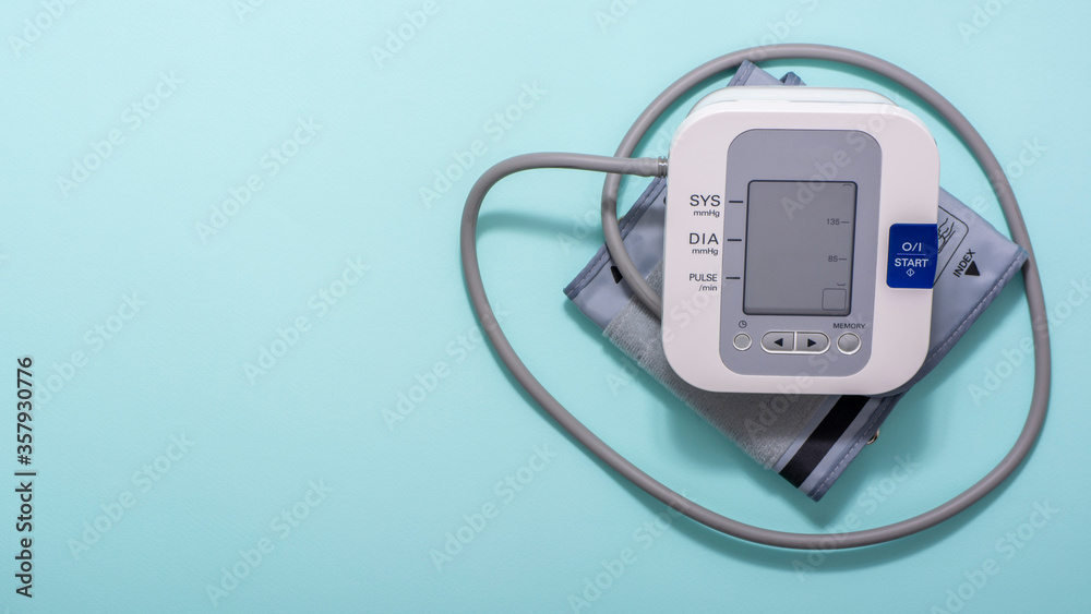 Device for measuring blood pressure on a blue medical background. Copy space. Device for measuring blood pressure on a blue medical background. Copy space.