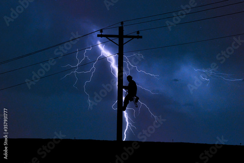 Lineman working in Lightning Storm photo